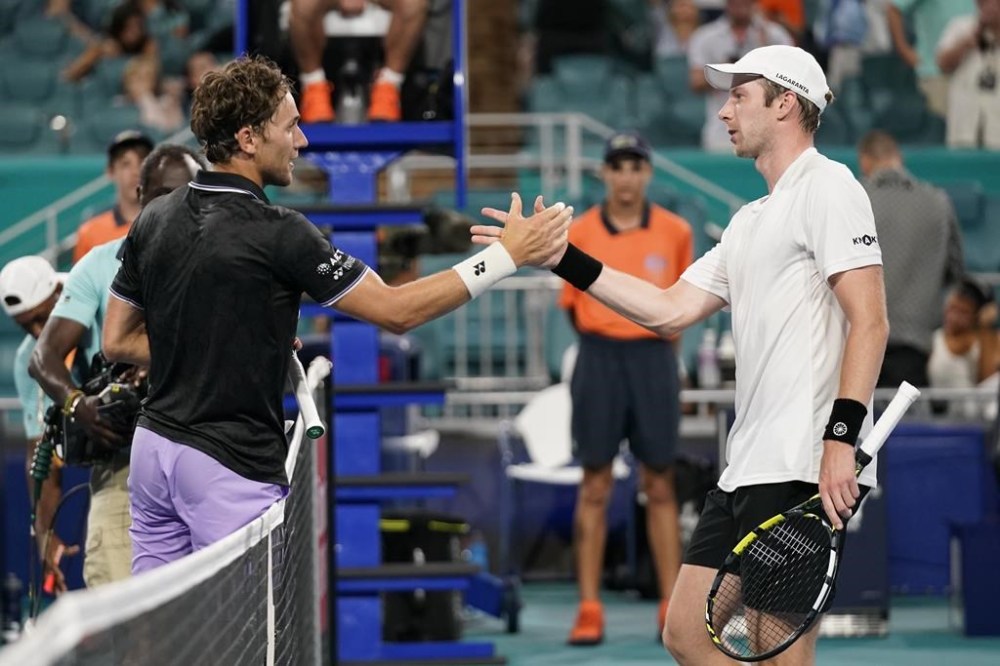 Botic van de Zandschulp, of the Netherlands, right, and Casper Ruud, of Norway, congratulate each other after van de Zandschulp beat Ruud, 3-6, 6-4, 6-4, during the Miami Open tennis tournament, Sunday, March 26, 2023, in Miami Gardens, Fla. (AP Photo/Wilfredo Lee)