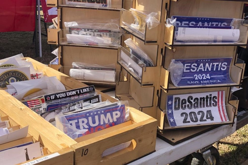FILE - Bumper stickers supporting Florida Gov. Ron DeSantis on sale at former President Donald Trump's rally in Conroe, Texas, Jan. 29, 2022. DeSantis’ allies are gaining confidence in his White House prospects as former President Donald Trump’s legal woes mount. Trump, a 2024 Republican presidential candidate, is facing possible criminal charges in New York, Georgia and Washington. The optimism around DeSantis comes even as a collection of Republican officials and MAGA influencers raise concerns about the Florida governor’s readiness for national stage. (AP Photo/Jill Colvin, File)