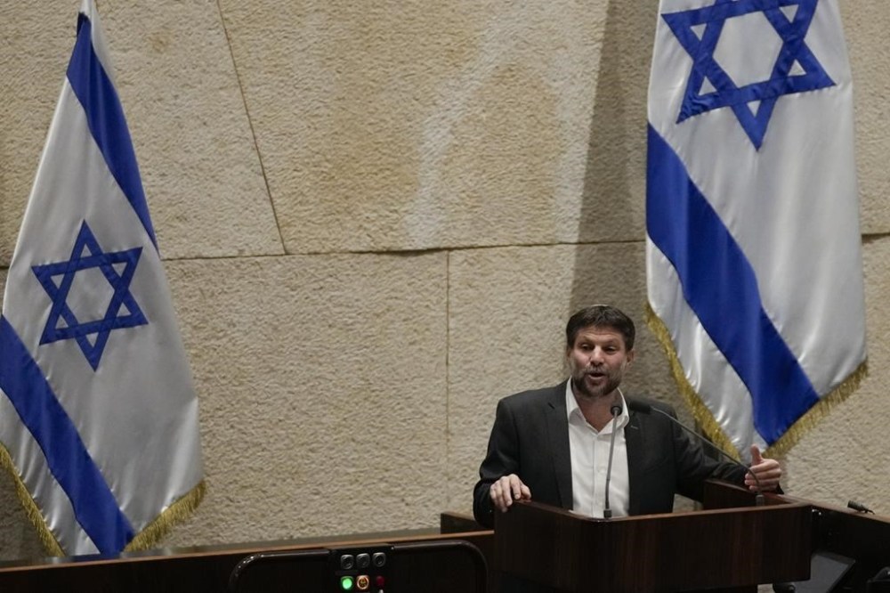 Bezalel Smotrich, Israeli Minister of Finance addresses the parliament in Jerusalem, Monday, March 27, 2023. Israel's largest trade union group launched a strike Monday across a broad swath of sectors, joining a surging protest movement against Prime Minister Benjamin Netanyahu's plan to overhaul the judiciar. (AP Photo/Maya Alerruzzo)