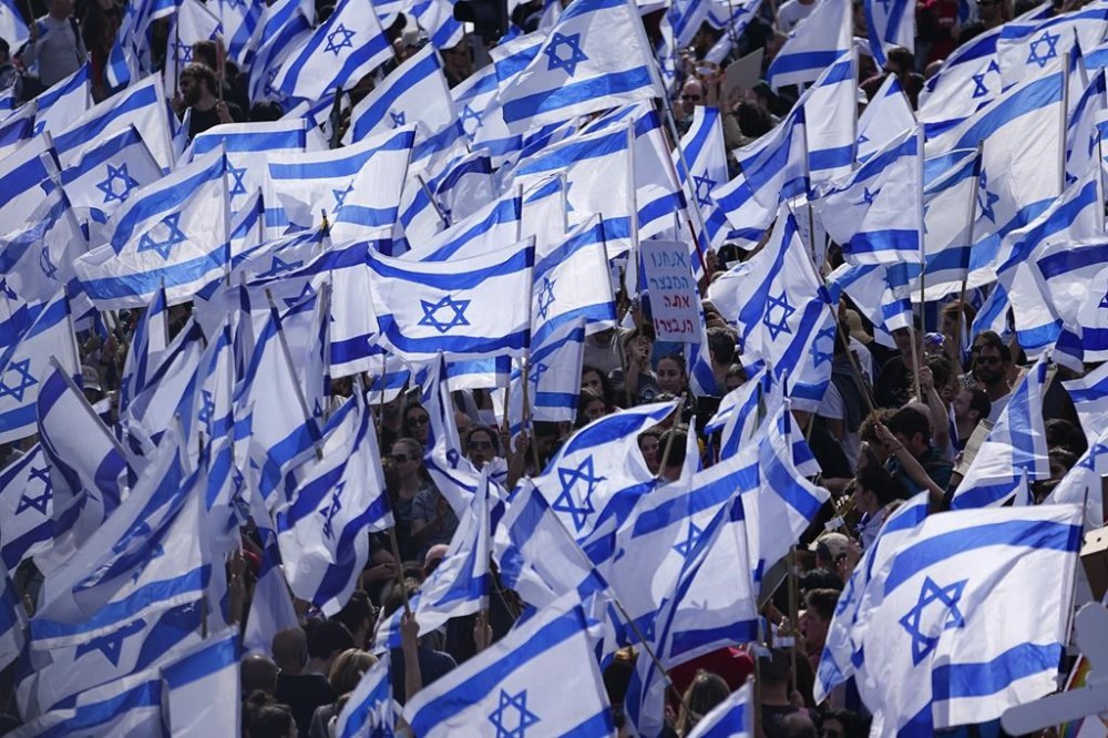 Israelis protest against Prime Minister Benjamin Netanyahu's judicial overhaul plan outside the parliament in Jerusalem, Monday, March 27, 2023. Israeli diplomats in Canada have joined a strike against Prime Minister Benjamin Netanyahu's plan to overhaul the country's judiciary. THE CANADIAN PRESS/AP/Ariel Schalit