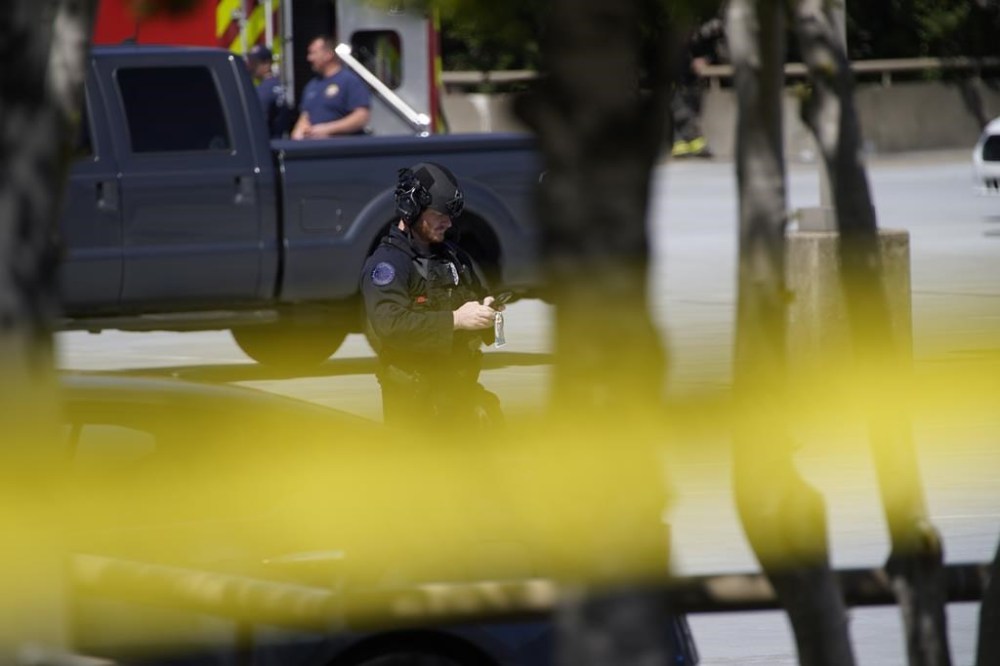 Metro Nashville Police officers work at the scene near The Covenant School, a private Christian school in Nashville, Tenn., following a deadly shooting Monday, March 27, 2023. A female shooter wielding two “assault-style” rifles and a pistol also died after being shot by police. (Andrew Nelles/The Tennessean via AP)