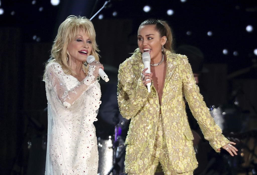 FILE - Dolly Parton, left, and Miley Cyrus perform 