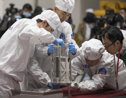 FILE - In this Thursday, Dec. 17, 2020 photo provided by China's Xinhua News Agency, technicians prepare to weigh a container carrying moon samples retrieved by China's Chang'e 5 lunar lander in Beijing. In a report published in the journal Nature Geoscience on Monday, March 27, 0223, scientists announced they have discovered a new and renewable source of water on the moon for future explorers in the lunar samples. Water was embedded in tiny glass beads in the lunar dirt where meteorite impacts occur. (Jin Liwang/Xinhua via AP, File)