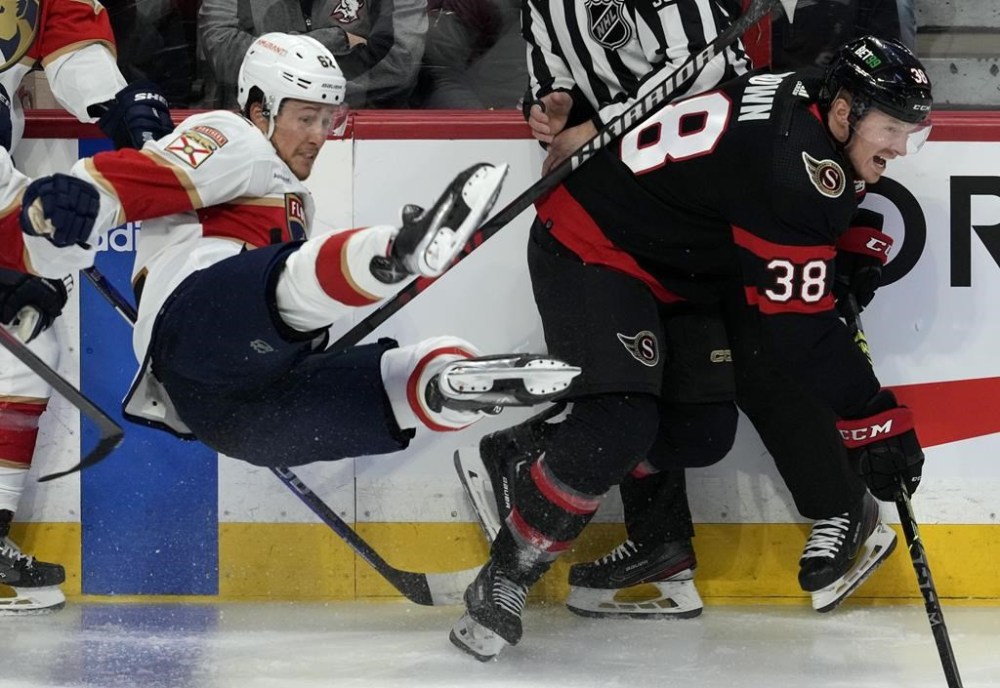 Ottawa Senators centre Patrick Brown (38) skates past a falling Florida Panthers defenceman Brandon Montour (62) during second period NHL action on Monday, March 27, 2023 in Ottawa. THE CANADIAN PRESS/Adrian Wyld