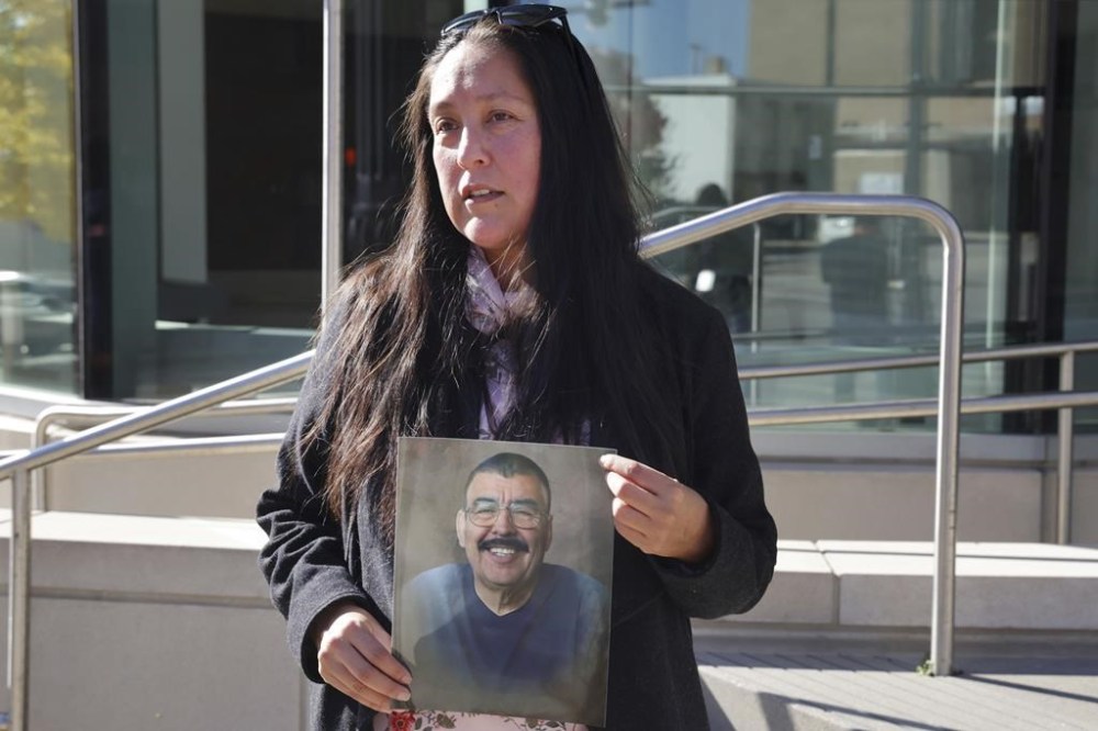 Ashbey Beasley holds a photo of murder victim Eduardo Uvaldo outside of the Lake County Courthouse following a hearing for Robert E. Crimo III, who is accused of murder in the Highland Park Fourth of July shootings, on Nov. 1, 2022, in Waukegan, Ill. Beasley, who has been pushing Congress to pass a ban on semiautomatic weapons, rushed to the scene of the Nashville school shooting on Monday, March 27, 2023, while she was on her way to visit a mother of previous mass shooting victim. (Stacey Wescott/Chicago Tribune via AP)
