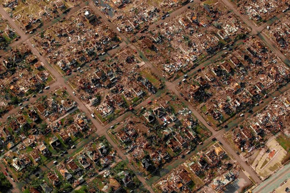 FILE - A neighborhood destroyed by a tornado is seen in Joplin, Mo., May 24, 2011. A new study says warming will fuel more supercells or tornados in the United States and that those storms will move eastward from their current range. (AP Photo/Charlie Riedel, File)
