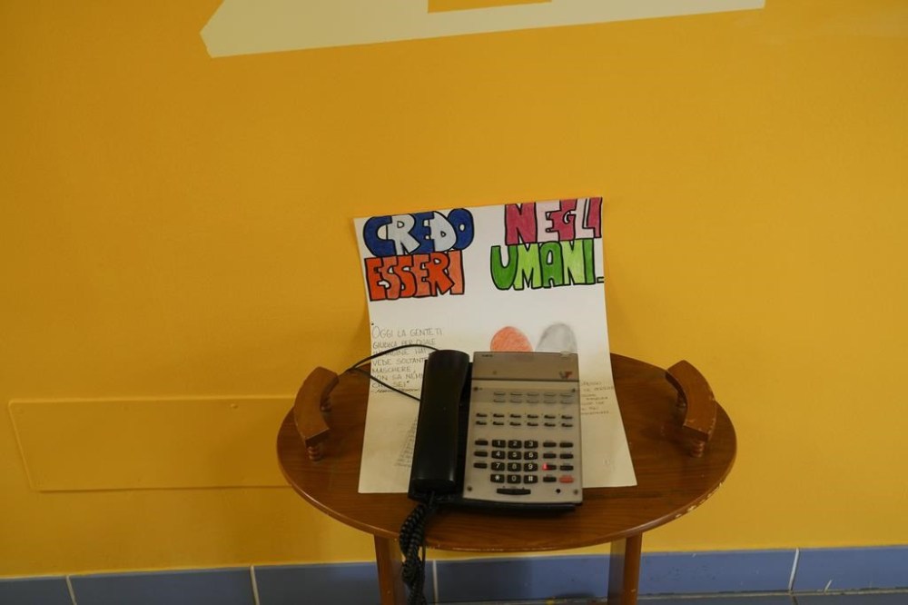A phone sits on a paper sheet reading: