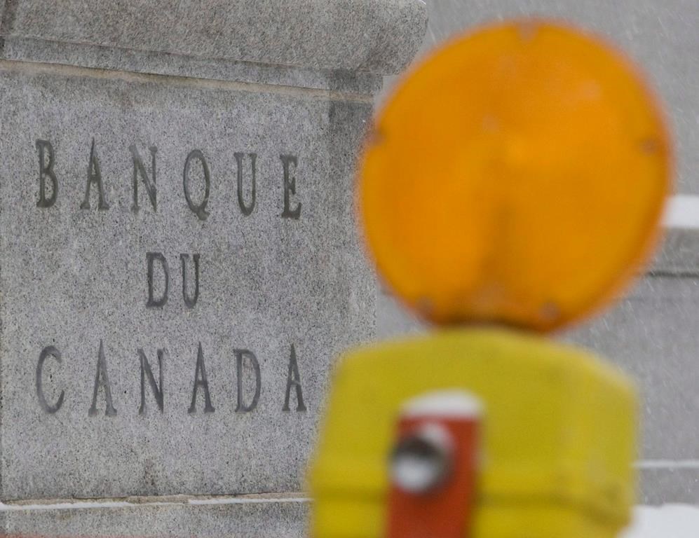 New research says Canada is heading into a mild recession as elevated borrowing costs, a downturn in the U.S. and persistent inflation dial up the economic uncertainty. A construction warning light sits on a sign on the sidewalk outside the Bank of Canada in Ottawa, Tuesday, Dec. 9, 2008. THE CANADIAN PRESS/Adrian Wyld