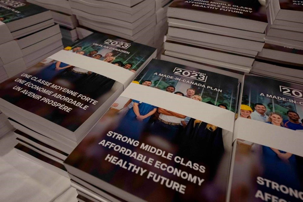 Copies of the Federal budget are seen on a table Tuesday, March 28, 2023 in Ottawa. THE CANADIAN PRESS/Adrian Wyld