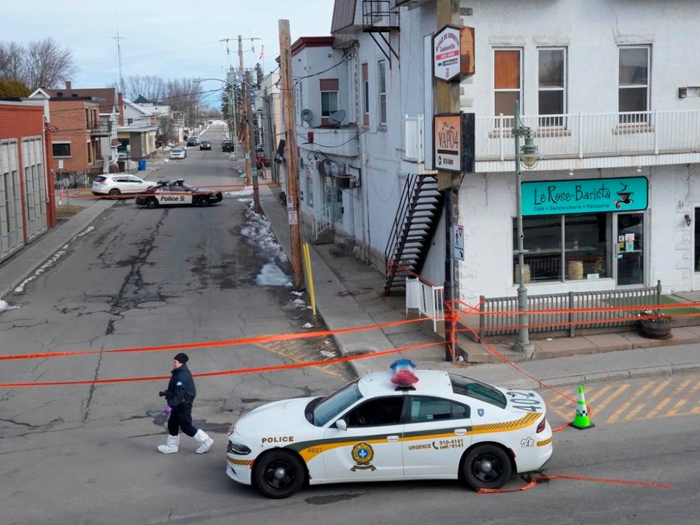 Police tape cordons off the scene after a Quebec provincial police officer was killed while trying to arrest a man in Louiseville, Que., Tuesday, March 28, 2023. THE CANADIAN PRESS/Ryan Remiorz