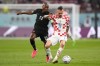Croatia midfielder Marcelo Brozovic (11) plays the ball as Canada midfielder Atiba Hutchinson (13) defends during first half group F World Cup soccer action at the Khalifa International Stadium in Al Rayyan, Qatar on Sunday, November 27, 2022. Hutchinson earned cap No. 103 coming off the bench in Canada's 4-1 win over Honduras on Tuesday. THE CANADIAN PRESS/Nathan Denette