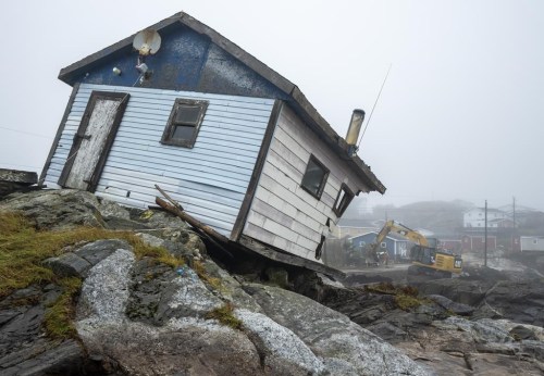 Workers start to clean up the devastation left by Hurricane Fiona in Burnt Island, N.L. on Wednesday Sept. 28, 2022. The federal government committed $31.7 million over three years in its latest budget to a low-cost flood insurance program. THE&nbsp;CANADIAN PRESS/Frank Gunn