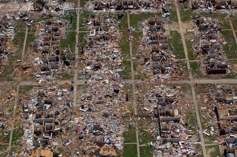 FILE - Debris covers the ground in the aftermath of a tornado in Tuscaloosa, Ala., May 7, 2011. Meteorologists are warning of a series of severe storms that could rip across America’s Midwest and South over the next couple of weeks. One weather expert said the current persistent pattern of storm ingredients is consistent with the April 2011 tornado onslaught, one of the largest, deadliest and most destructive tornado outbreaks in American history. (AP Photo/Dave Martin, File)