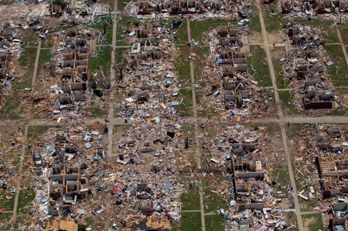 FILE - Debris covers the ground in the aftermath of a tornado in Tuscaloosa, Ala., May 7, 2011. Meteorologists are warning of a series of severe storms that could rip across America’s Midwest and South over the next couple of weeks. One weather expert said the current persistent pattern of storm ingredients is consistent with the April 2011 tornado onslaught, one of the largest, deadliest and most destructive tornado outbreaks in American history. (AP Photo/Dave Martin, File)