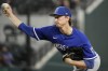 Kansas City Royals starting pitcher Brady Singer throws a pitch during the first inning of a spring training baseball game against the Texas Rangers on Tuesday, March 28, 2023, in Arlington, Texas. (AP Photo/Sam Hodde)