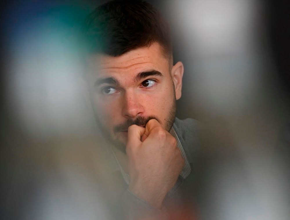 Hamburger SV soccer player Mario Vuskovic reacts after taking his seat for the third hearing before the Sports Court of the German Football Association (DFB), in Frankfurt, Germany, Friday March 17, 2023. Hamburger SV defender Mario Vuskovic was banned for two years Thursday, March 20, 2023, in a doping case. (Arne Dedert/dpa via AP)