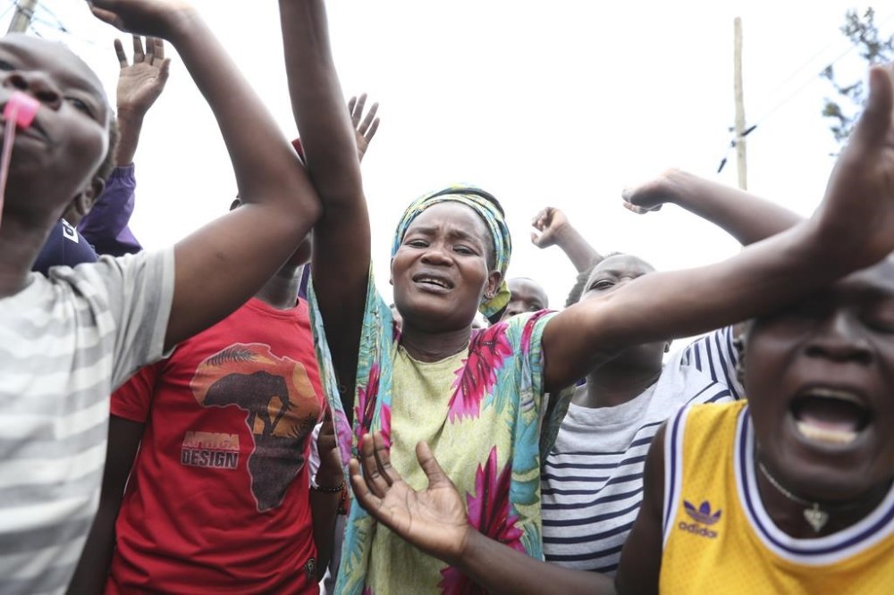 Residents raise their hands during a mass rally called by the opposition leader Raila Odinga over the high cost of living in Mathari Slums, Kenya, Thursday, March 30, 2023. Police in Kenya are on high alert ahead of the third round of anti-government protests organized by the opposition that has been termed as illegal by the government. (AP Photo/Brian Inganga)