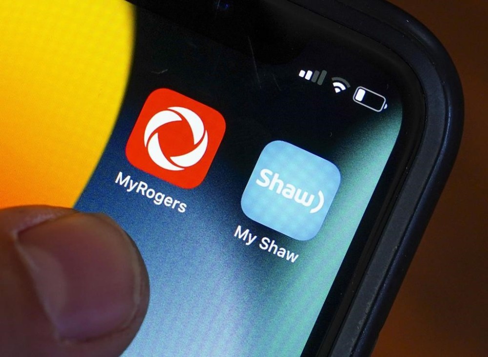 Rogers and Shaw applications are pictured on a cellphone in Ottawa on Monday, May 9, 2022. THE CANADIAN PRESS/Sean Kilpatrick