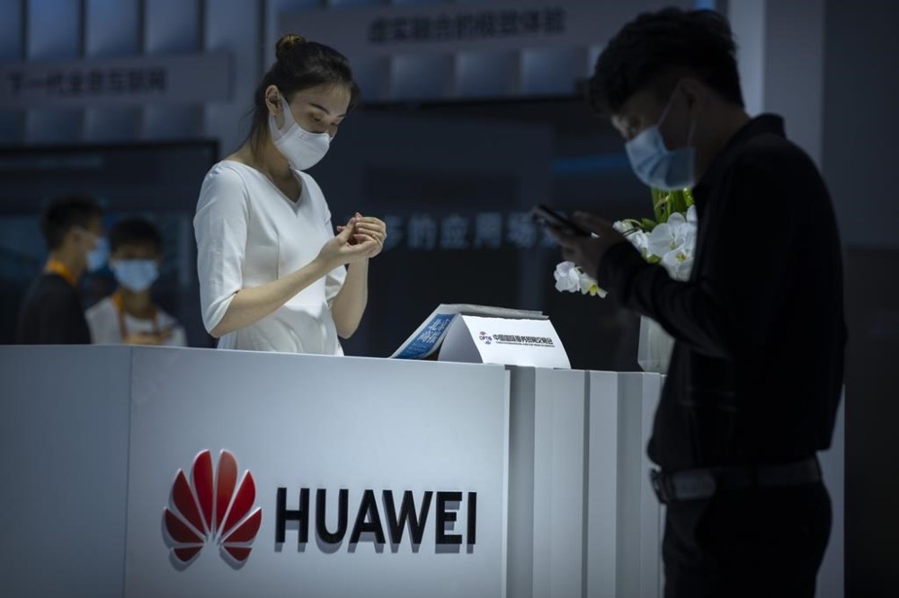 A staff member stands at a booth for Chinese technology firm Huawei at the China International Fair for Trade in Services (CIFTS) in Beijing, Friday, Sept. 3, 2021. Huawei on Friday, March 31, 2023 reported a nearly 70% decline in profit last year amid sanctions and pandemic challenges, but its enterprise sales rose as the Chinese technology giant sought to pivot into digital industries and reduce its vulnerabilities to U.S. sanctions. (AP Photo/Mark Schiefelbein)