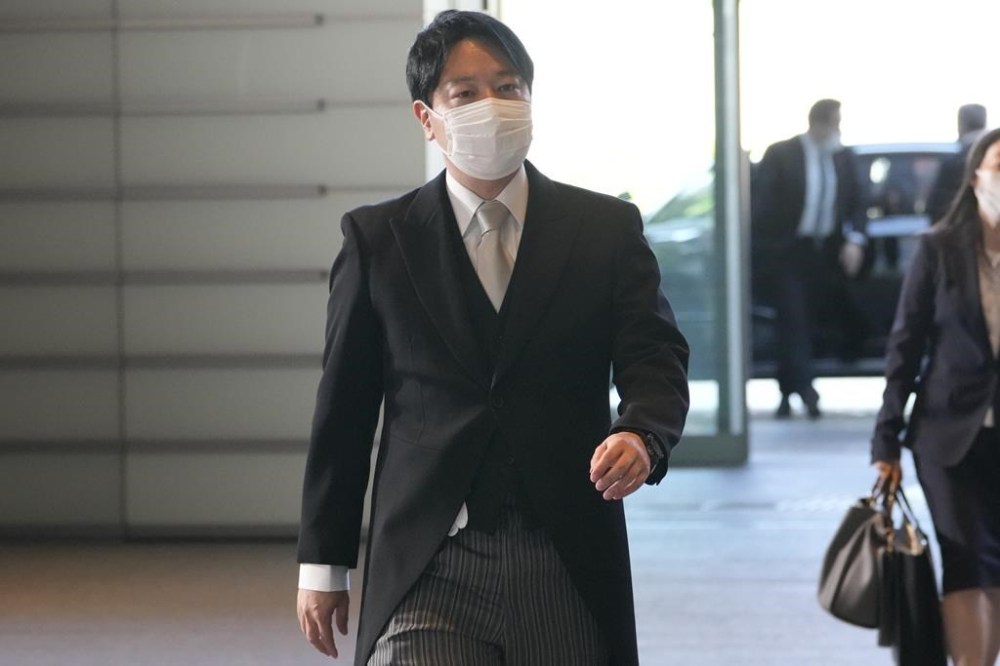 FILE - Newly appointed Minister of State for Measures for Declining Birthrate Masanobu Ogura arrives at the prime minister's office on Aug. 10, 2022, in Tokyo. Ogura, the Japanese minister in charge of tackling declining birthrates unveiled a draft proposal Friday, March 31, 2023, aimed at reversing the downtrend, including increased subsidies for childrearing and education and a salary increase for younger generations to incentivize marrying and having kids. (AP Photo/Shuji Kajiyama, File)
