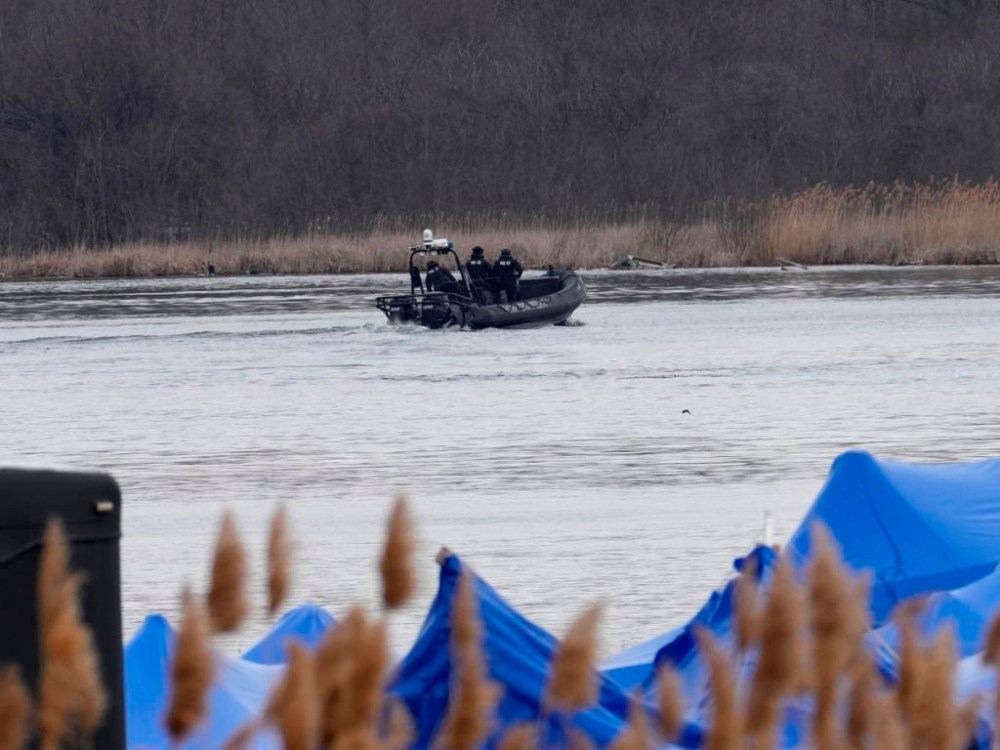 A police boat searches the area in Akwesasne, Que., Friday, March 31, 2023. Authorities in the Mohawk Territory of Akwesasne say one child is missing after the bodies of six migrants of Indian and Romanian descent were pulled from the river Thursday. THE CANADIAN PRESS/Ryan Remiorz