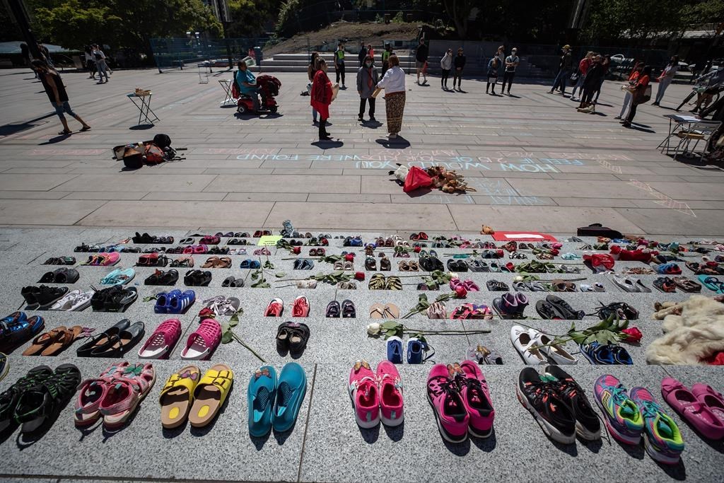 Two hundred and fifteen pairs of children's shoes are placed on the steps of the Vancouver Art Gallery n Vancouver on Friday, May 28, 2021, as a memorial to children who did not return from residential schools. THE CANADIAN PRESS/Darryl Dyck
