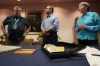 Peter Mangan, center, and his wife, Karen, right, stand with Lyndon B. Johnson presidential library director Mark Lawrence, left, as they prepare to make a donation to the library, Wednesday, Aug. 31, 2022, in Austin, Texas. The family of the late Associated Press reporter James W. Mangan has donated to the library cassette tapes containing interviews the reporter did that led to a 1977 story in which a Texas voting official detailed how three decades earlier, votes were falsified to give Johnson a slim victory in a U.S. Senate primary. (AP Photo/Eric Gay)