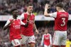 Arsenal's Bukayo Saka, left, celebrates with teammates after scoring his side's fourth goal during the English Premier League soccer match between Arsenal and Crystal Palace at Emirates stadium in London, Sunday, March 19, 2023. (AP Photo/Kirsty Wigglesworth)