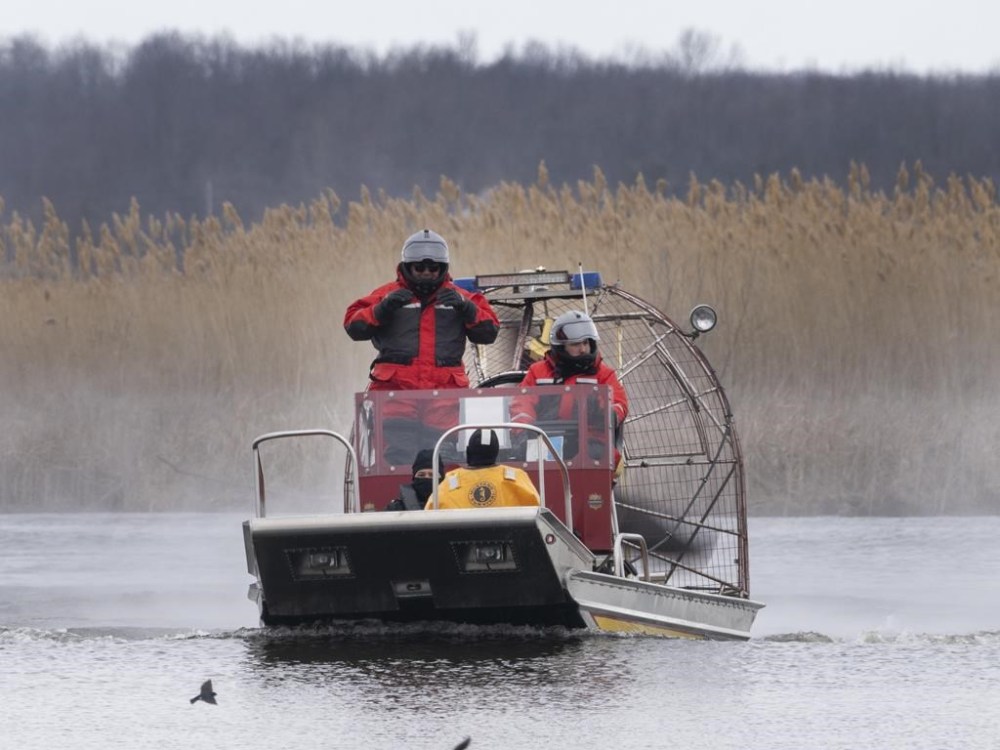 Searchers look for victims Friday, March 31, 2023 after a boat capsized and left six people dead and one infant missing in Akwesasne, Que. THE CANADIAN PRESS/Ryan Remiorz