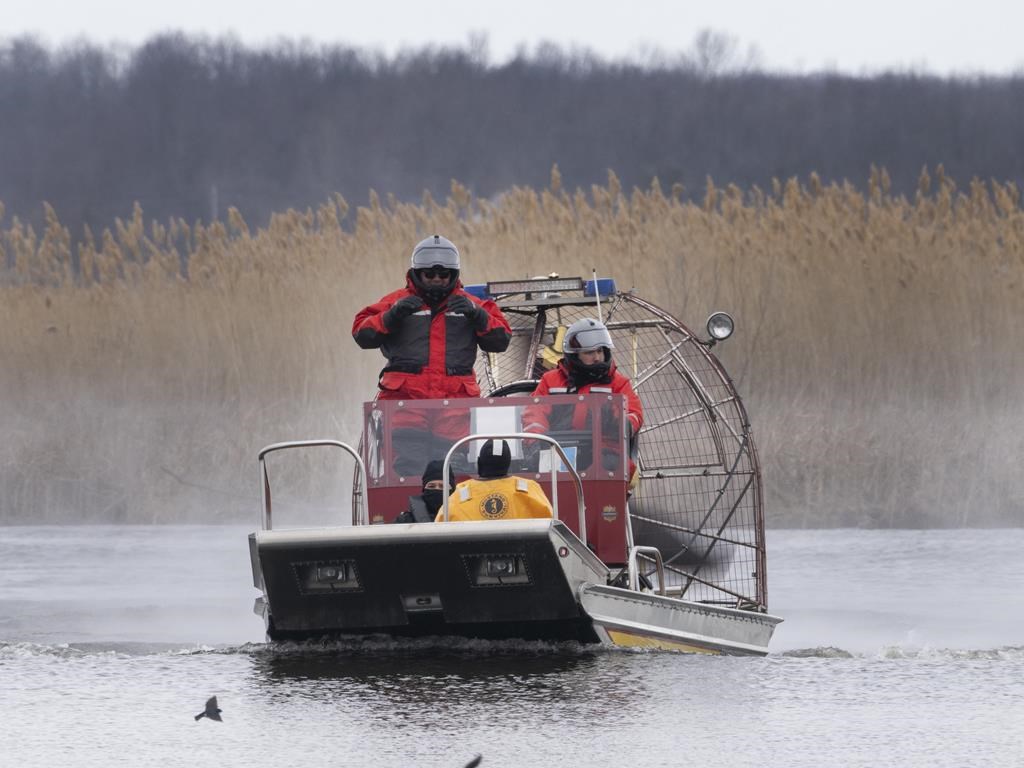 Searchers look for victims Friday, March 31, 2023 after a boat capsized and left six people dead and one infant missing in Akwesasne, Que. THE CANADIAN PRESS/Ryan Remiorz