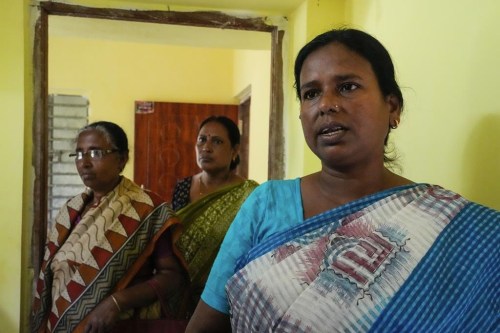 Kakali Halder talks as two members look on at her center in Mathurapur, South 24 Parganas, India, Monday, March 27, 2023. Halder and several hundred fellow seamstresses at Mathurapur Sanghati Swayamber Sangha, a group that make clothing items and share the proceeds between them, have worked with the stress of trying to get orders out when they can't rely on the electricity. (AP Photo/Bikas Das)