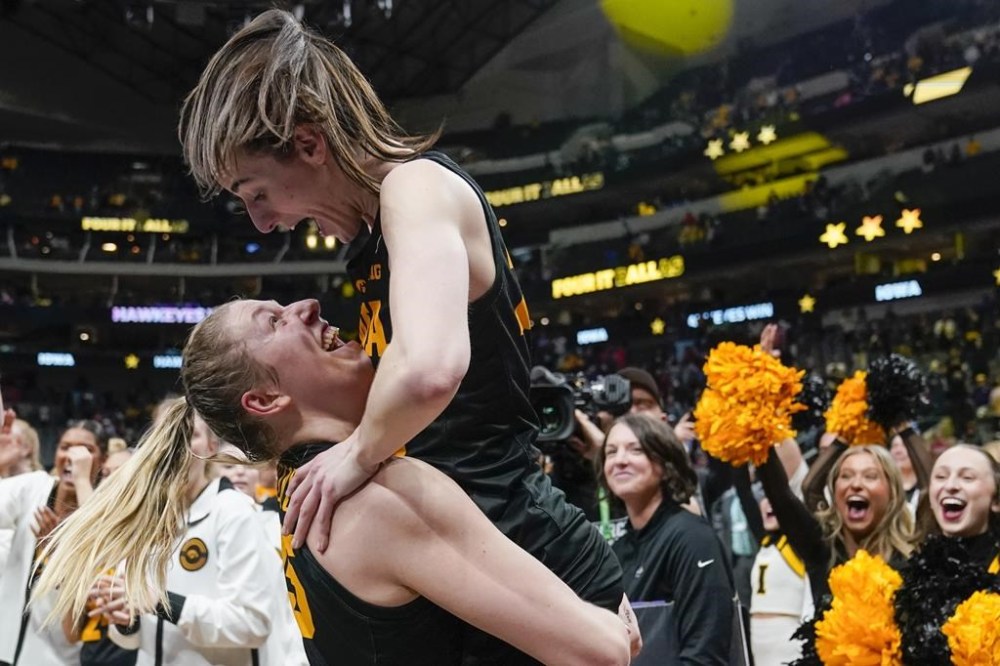 Iowa's Caitlin Clark and Monika Czinano celebrate after an NCAA Women's Final Four semifinals basketball game against South CarolinaFriday, March 31, 2023, in Dallas. Iowa won 77-73 to advance to the championship on Sunday. (AP Photo/Tony Gutierrez)