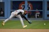Arizona Diamondbacks second baseman Ketel Marte can't get to a ball hit for a single by Los Angeles Dodgers' Max Muncy during the first inning of a baseball game Friday, March 31, 2023, in Los Angeles. (AP Photo/Mark J. Terrill)