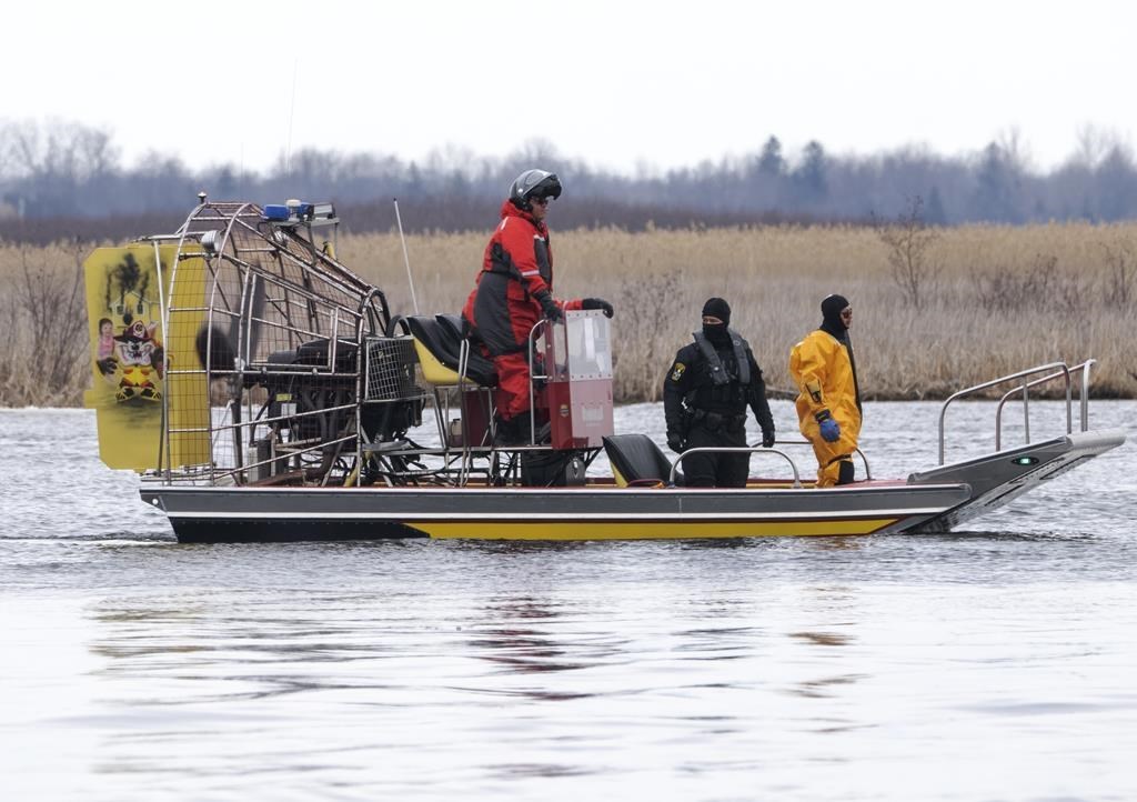 Searchers look for victims Friday, March 31, 2023. The bodies of eight migrants were pulled from the St. Lawrence River in Akwesasne, Que. THE CANADIAN PRESS/Ryan Remiorz