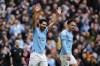 Manchester City's Ilkay Gundogan, left, celebrates after scoring his his side's third goal during the English Premier League soccer match between Manchester City and Liverpool at Etihad stadium in Manchester, England, Saturday, April 1, 2023. (AP Photo/Jon Super)