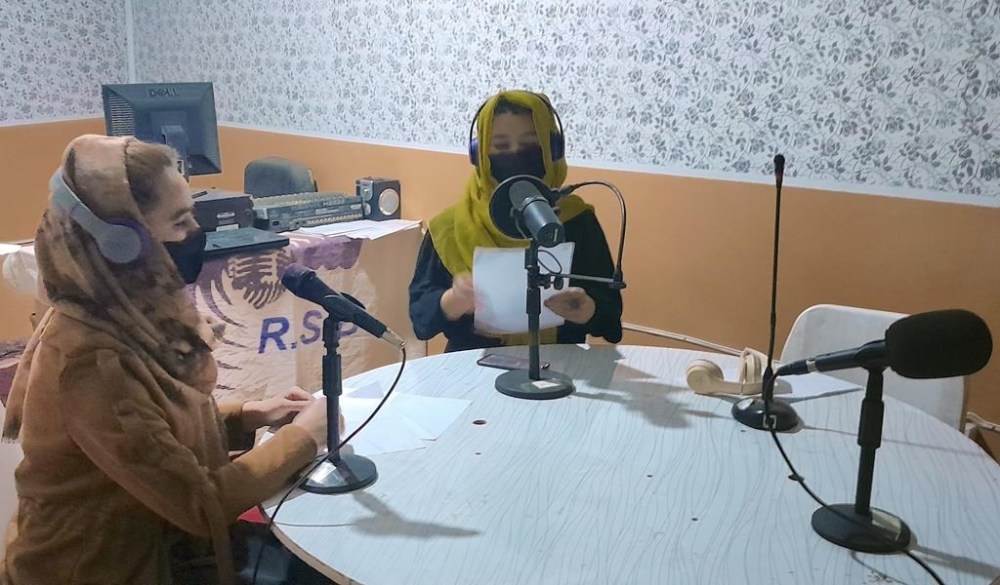Najia Sorosh head of Sadai Banowan a women-run radio station, left, speaks into a microphone in the broadcasting studio in Badakhshan province, north-eastern of Afghanistan, Wednesday, Jan. 4, 2023. A women-run radio station in Afghanistan's northeast has been shut down for playing music during the holy month of Ramadan, a Taliban official said Saturday. (Sadai Banowan via AP)