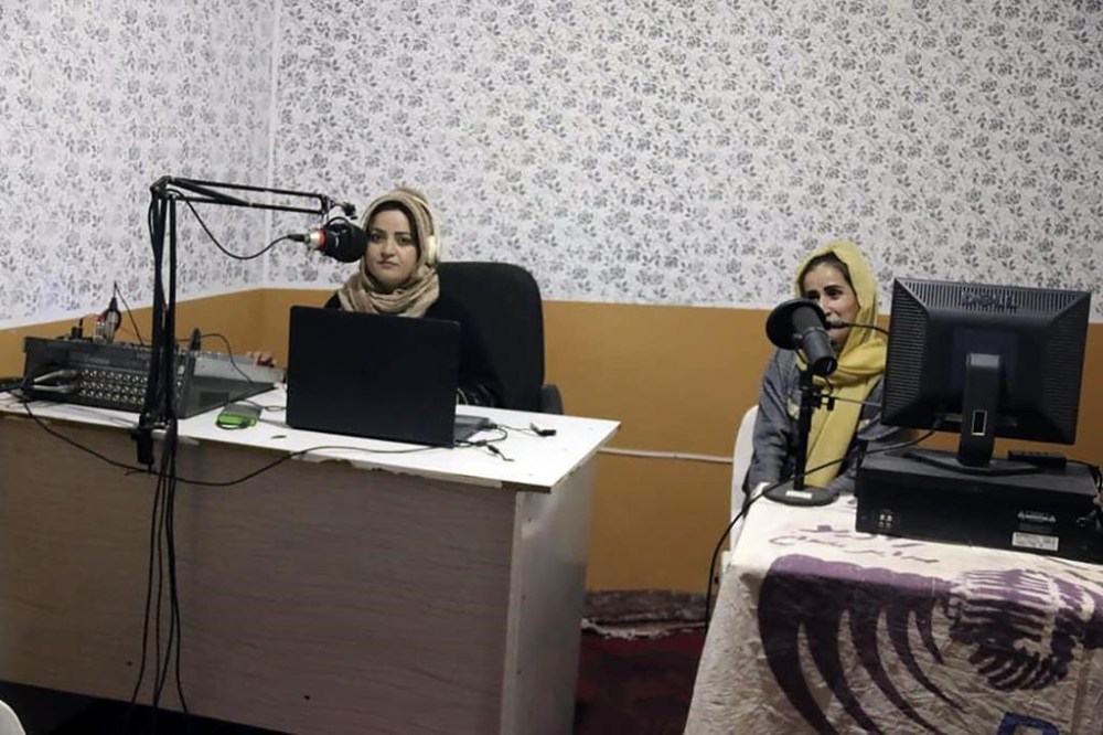 Najia Sorosh head of Sadai Banowan a women-run radio station, left, speaks into a microphone in the broadcasting studio in Badakhshan province, north-eastern of Afghanistan, Wednesday, Jan. 4, 2023. A women-run radio station in Afghanistan's northeast has been shut down for playing music during the holy month of Ramadan, a Taliban official said Saturday. (Sadai Banowan via AP)