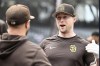San Diego Padres first baseman Jake Cronenworth, right, talks with a teammate during warmups before a baseball game against the Colorado Rockies in San Diego, Thursday, March 30, 2023. (AP Photo/Alex Gallardo)