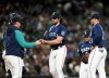 Seattle Mariners starting pitcher Robbie Ray (38) gives the ball to manager Scott Servais as he is taken out of the baseball game against the Cleveland Guardians during the fourth inning Friday, March 31, 2023, in Seattle. (AP Photo/Lindsey Wasson)