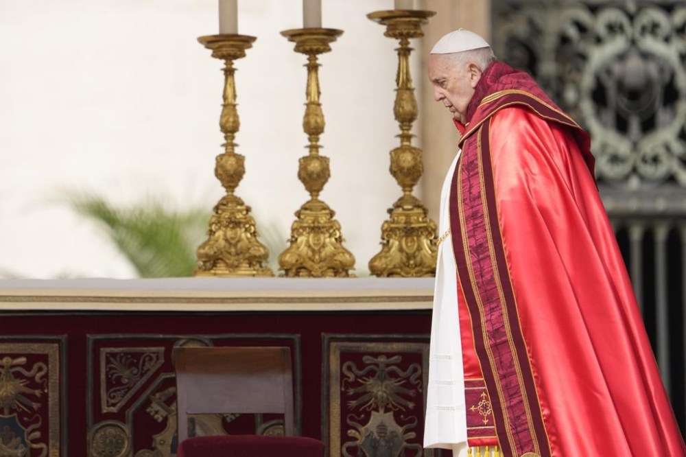 Pope Francis arrives on the altar to celebrate the Palm Sunday's mass in St. Peter's Square at The Vatican Sunday, April 2, 2023 a day after being discharged from the Agostino Gemelli University Hospital in Rome, where he has been treated for bronchitis, The Vatican said. The Roman Catholic Church enters Holy Week, retracing the story of the crucifixion of Jesus and his resurrection three days later on Easter Sunday. (AP Photo/Andrew Medichini)