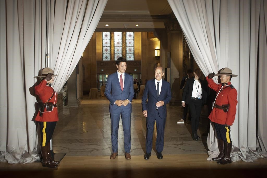 Prime Minister Justin Trudeau, left, and German Chancellor Olaf Scholz arrive for a dinner in Toronto on Monday, August 22, 2022. A new report suggests Canada should be doing more to make its abundant natural gas riches a key component of the world's effort to move to a lower-carbon future. THE CANADIAN PRESS/Chris Young