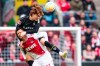 Cologne's Davie Selke, bottom, and Gladbach's Ko Itakura fight for the ball during the German Bundesliga soccer match between Cologne and Borussia Moenchengladbach, at the RehinEnergioStadion in Cologne, Germany, Sunday, April 3, 2023. (Marius Becker/dpa via AP)