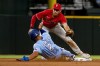 Texas Rangers' Marcus Semien (2) attempts to slide into second base as Philadelphia Phillies shortstop Trea Turner, top, tags him out in the bottom of the first inning in a baseball game in Arlington, Texas, Sunday, April 2, 2023. (AP Photo/Emil T. Lippe)