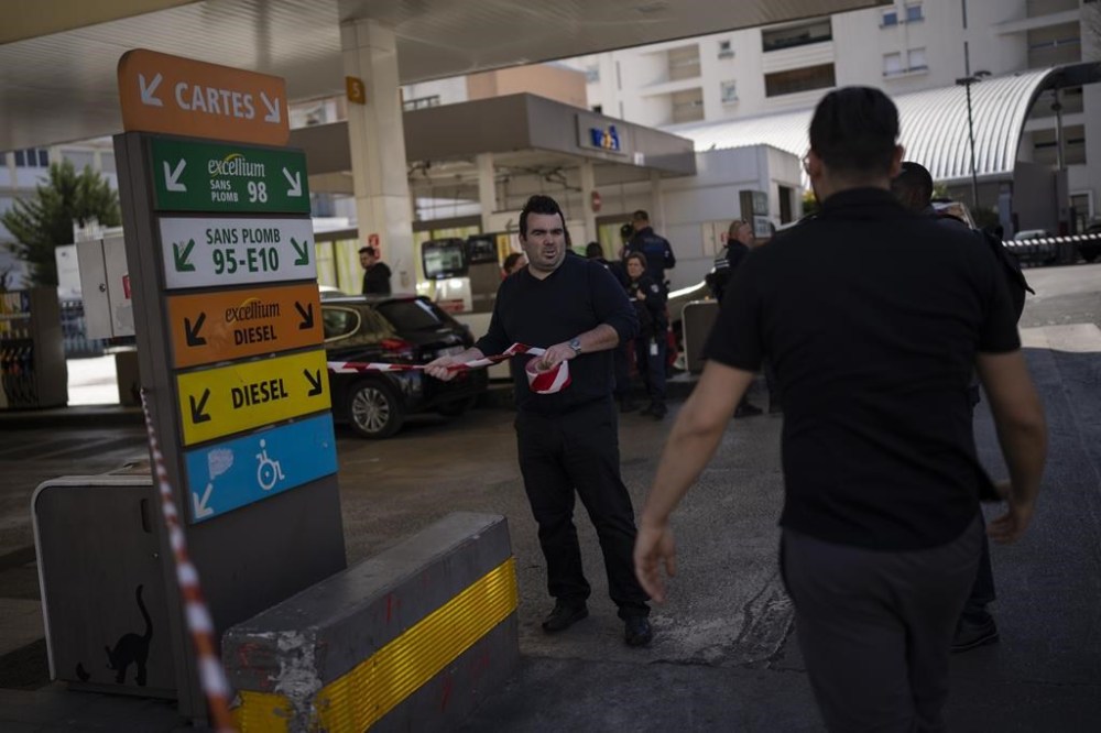 FILE - A gas station worker closes off a gas station in Marseille, southern France, on March 20, 2023. Major oil-producing countries led by Saudi Arabia and Russia have said they're throttling back supplies of crude — again. And this time, the decision to cut back was a surprise that is underlining worries about where the global economy might be headed. (AP Photo/Daniel Cole, File)
