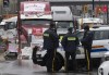 Police officers keep an eye on protest trucks, Thursday, February 17, 2022 in Ottawa. The Ottawa's People Commission is releasing part two of their final report into the impact that last winter's weeks-long protest had on residents and with it 25 recommendations to rebuild community trust.THE CANADIAN PRESS/Adrian Wyld