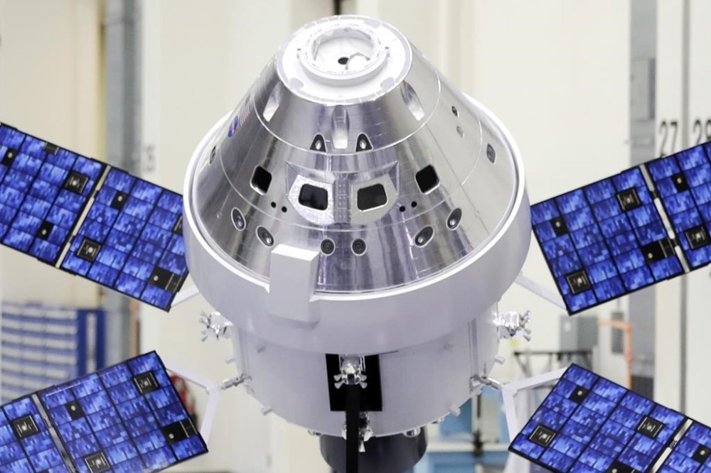FILE - A model of the Orion capsule and the service module is displayed at the Kennedy Space Center in Cape Canaveral, Fla., on Friday, Nov. 16, 2018. On Monday, April 3, 2023, NASA revealed the identities of the four astronauts – three US and one Canadian– who will fly around the moon in late 2024. It's the first moon crew in more than 50 years. (AP Photo/John Raoux)