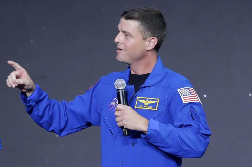 Reid Wiseman, mission commander, gives remarks during a NASA ceremony naming the four astronauts who will fly around the moon by the end of next year on the Artemis II mission, at a ceremony held in the NASA hanger at Ellington airport Monday, April 3, 2023, in Houston. (AP Photo/Michael Wyke)