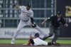 Houston Astros' Chas McCormick flies under Chicago White Sox second baseman Elvis Andrus (1) for a stolen base as umpire Rob Drake looks on during the second inning of a baseball game, Sunday, April 2, 2023, in Houston. (AP Photo/Kevin M. Cox)