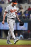 Baltimore Orioles starting pitcher Kyle Bradish walks off the field after injuring his foot during the second inning of a baseball game against the Texas Rangers in Arlington, Texas, Monday, April 3, 2023. (AP Photo/LM Otero)