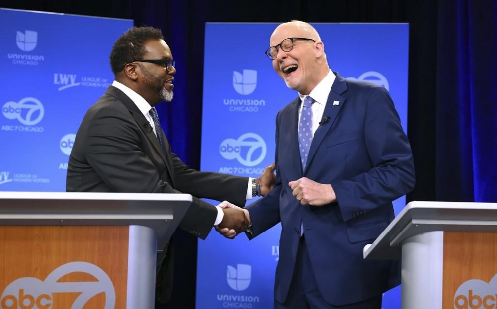 Chicago mayoral candidates Brandon Johnson, left, and Paul Vallas shake hands before the start of a debate at ABC7 studios in downtown Chicago, Thursday, March 16, 2023. (Chris Sweda/Chicago Tribune via AP, Pool)